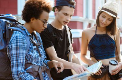 Young travellers with a map planning a trip abroad on a tourist visa