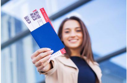 Professional holding a passport and boarding pass for a business visa